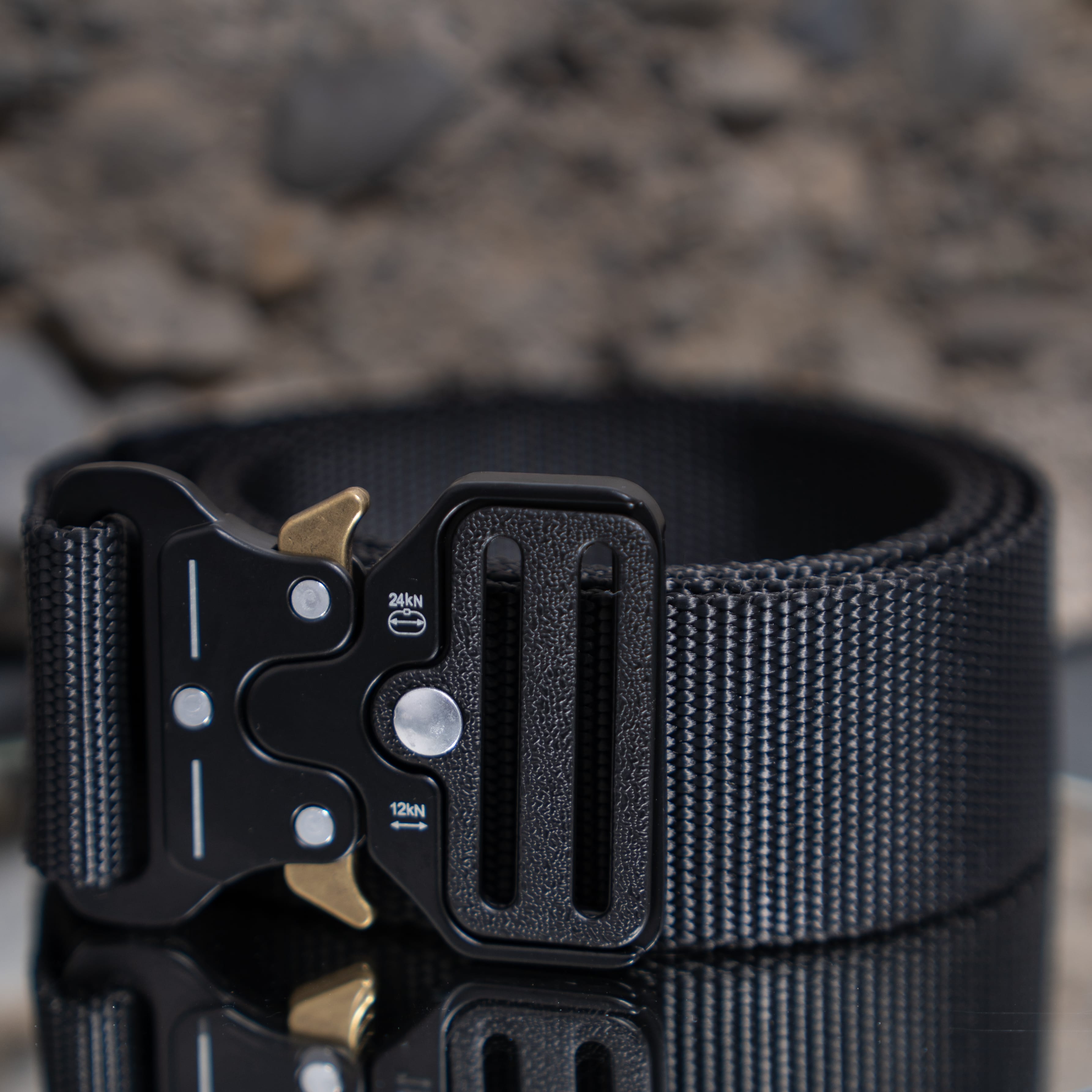 Schwarzer Army Coin Ch Gürtel mit robuster Metallschnalle auf reflektierender Oberfläche.